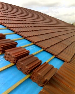 concrete tiles are being installed on a roof